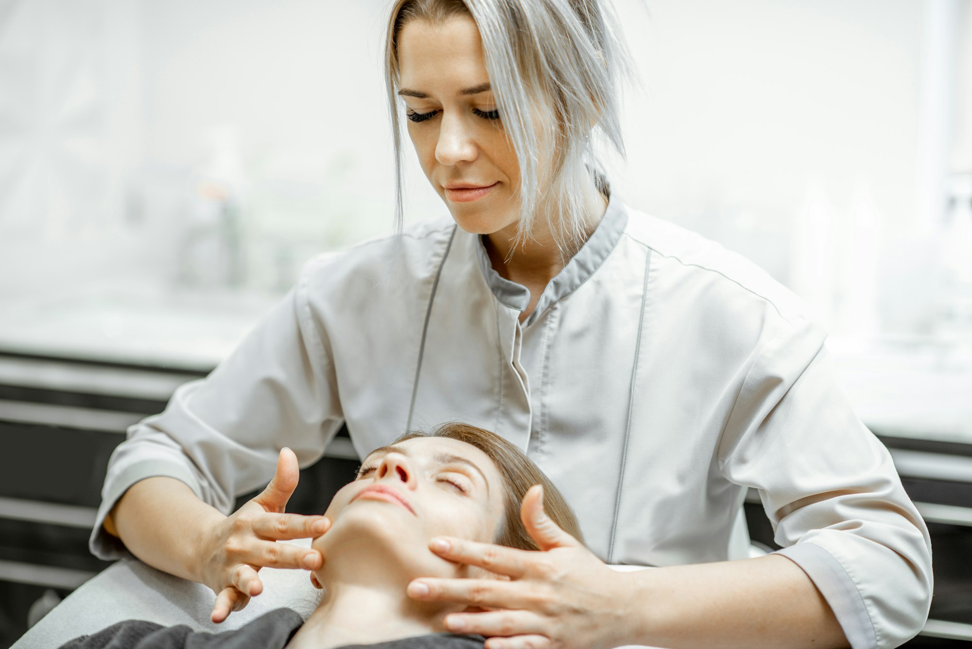 Woman during the facial massage at the beaty salon