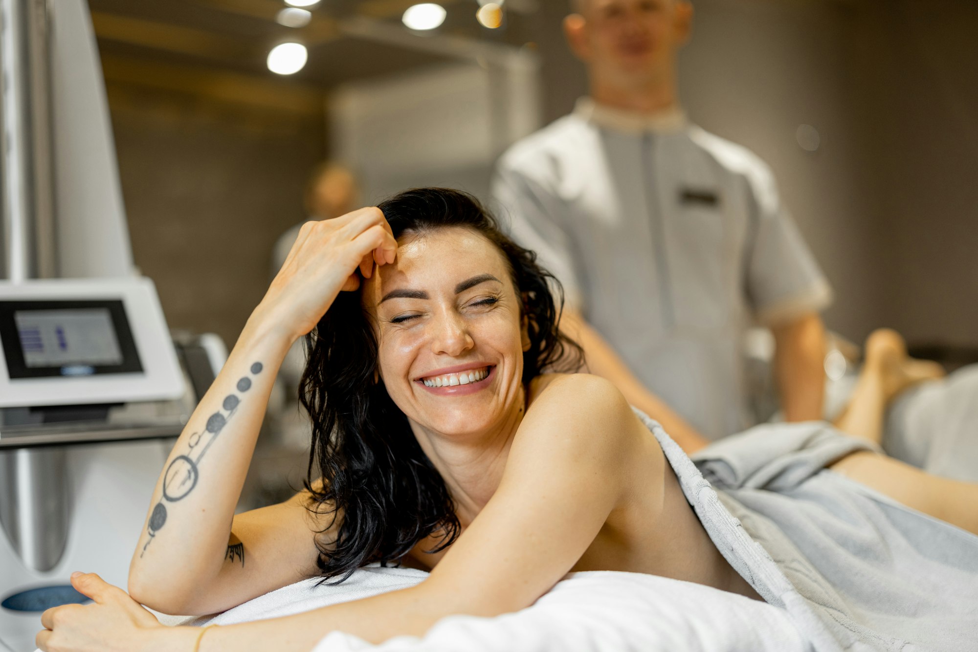 Woman receiving vacuum roller massage at beauty salon